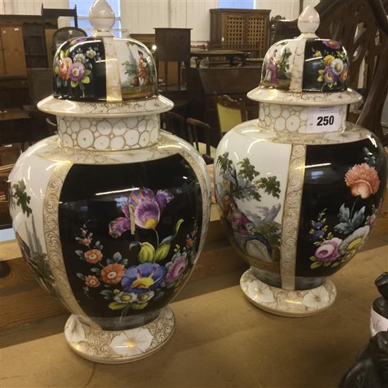 A pair of French gilt hand decorated, lidded vases